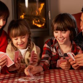 Family playing cards at Christmas