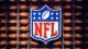 The NFL logo placed against a wall of footballs - fantasy NFL football