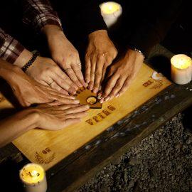 The Ouija Board with people playing it
