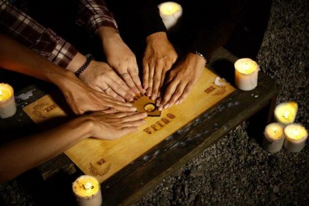 The Ouija Board with people playing it