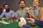 Photo of three freinds playing casino games at home to illustrate an article about Casino-Inspired Décor & Gift Ideas for Game Nights