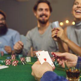 Photo of three freinds playing casino games at home to illustrate an article about Casino-Inspired Décor & Gift Ideas for Game Nights