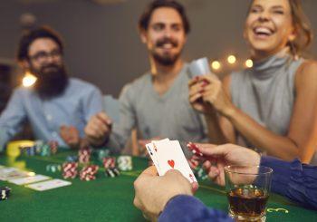 Photo of three freinds playing casino games at home to illustrate an article about Casino-Inspired Décor & Gift Ideas for Game Nights