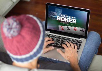 Top down photo of man in a toque playing poker on his laptop - The Importance of Responsible Gambling in Online Casino Communities