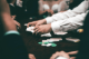 dealer and players playing a card game at a casino