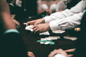 dealer and players playing a card game at a casino
